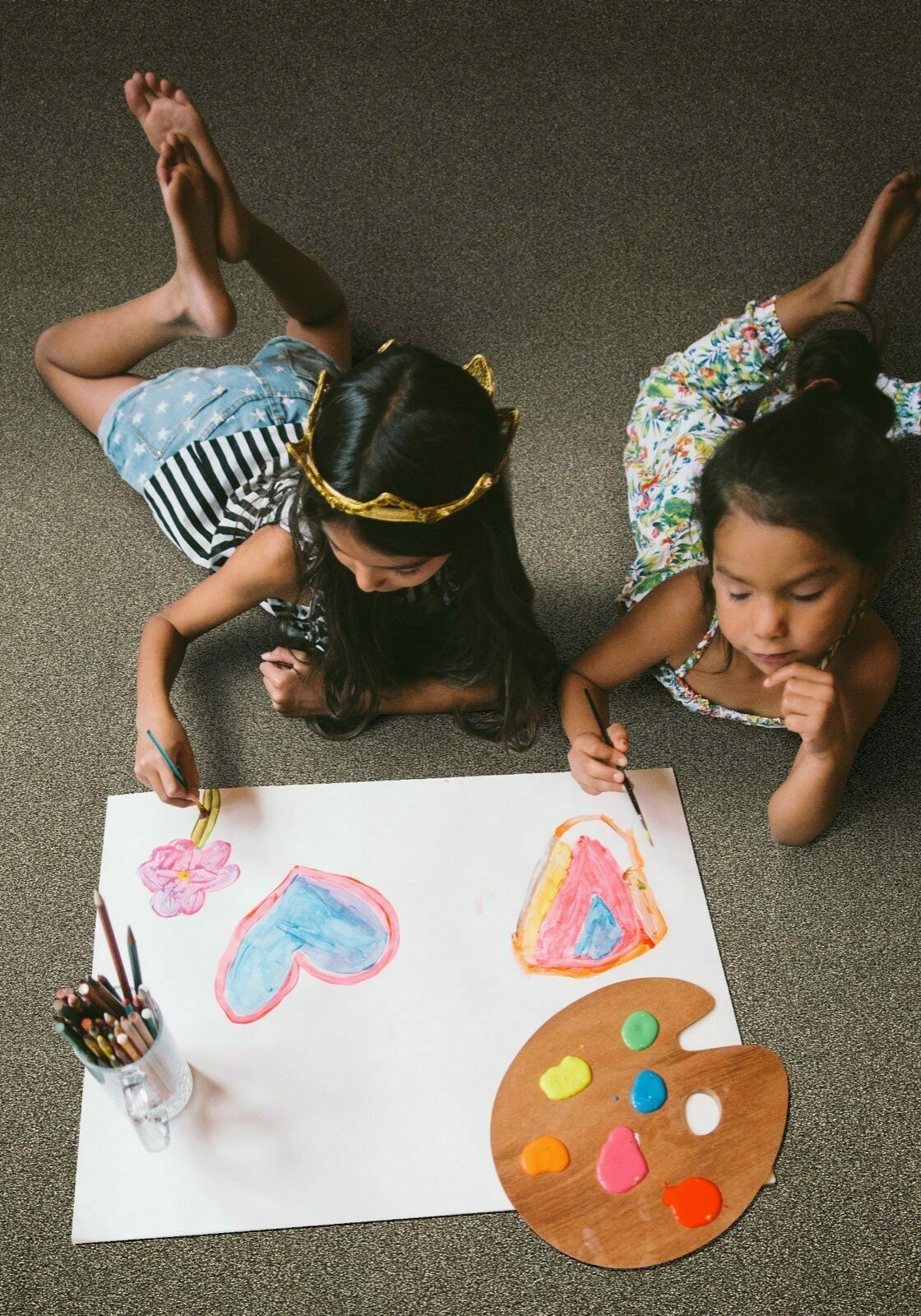 Girls draws laying on carpet | Rockland Interiors